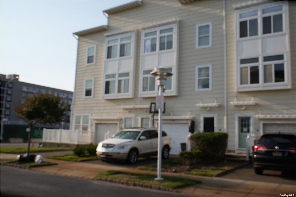 66-16 Seaspray Ave, Arverne, NY 11692 - view of front of house with an attached garage and driveway