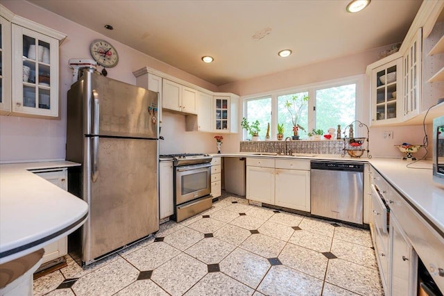 136 Linden St, Woodmere, NY 11598 - kitchen featuring appliances with stainless steel finishes, a sink, light countertops, recessed lighting, and white cabinetry