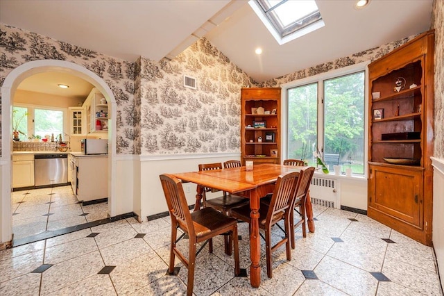 136 Linden St, Woodmere, NY 11598 - dining room featuring radiator, wainscoting, plenty of natural light, wallpapered walls, and a skylight