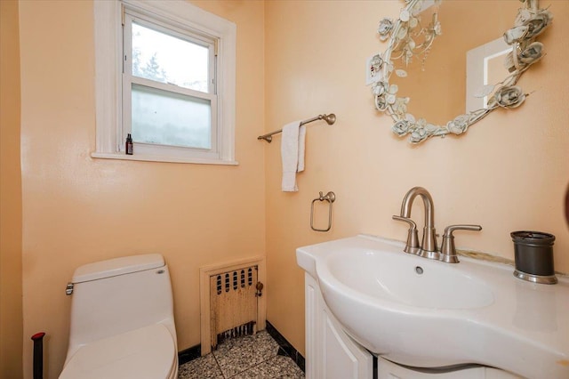 136 Linden St, Woodmere, NY 11598 - half bathroom with radiator heating unit, toilet, and vanity