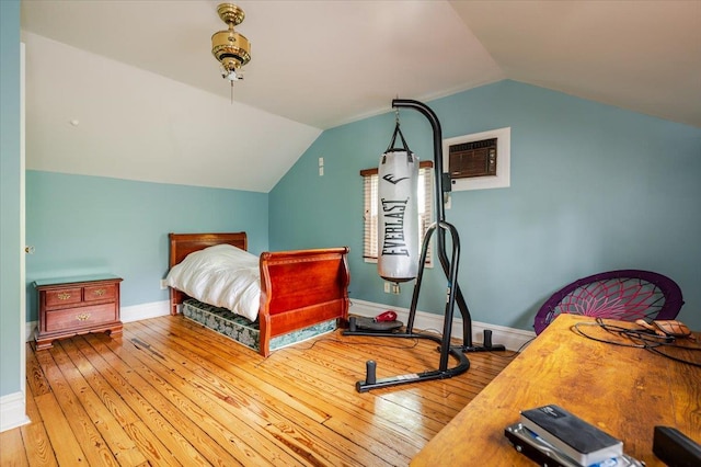 136 Linden St, Woodmere, NY 11598 - bedroom featuring hardwood / wood-style flooring, vaulted ceiling, a wall unit AC, and baseboards