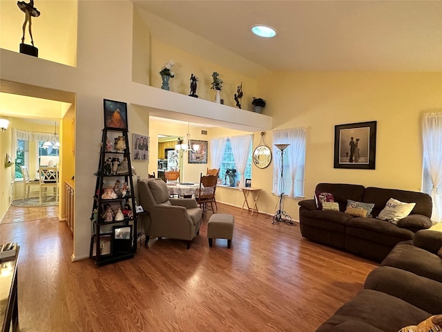 5 Baldwin Ct, Ridge, NY 11961 - living area with a chandelier, healthy amount of natural light, high vaulted ceiling, wood finished floors, and baseboards