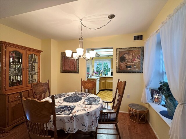 5 Baldwin Ct, Ridge, NY 11961 - dining room with a chandelier, wood finished floors, and baseboards