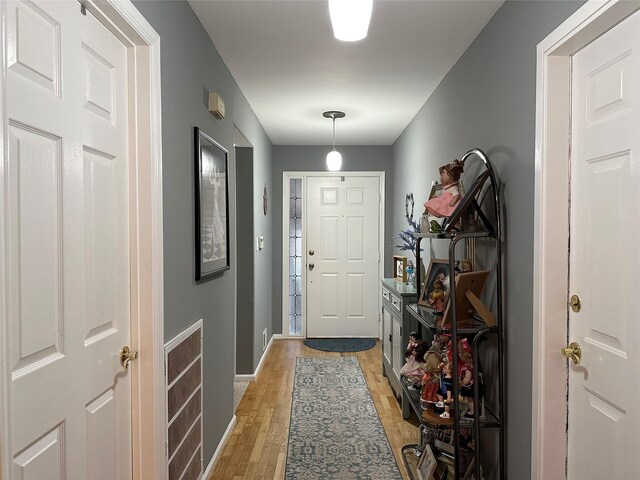 5 Baldwin Ct, Ridge, NY 11961 - foyer entrance with light wood-style flooring and baseboards