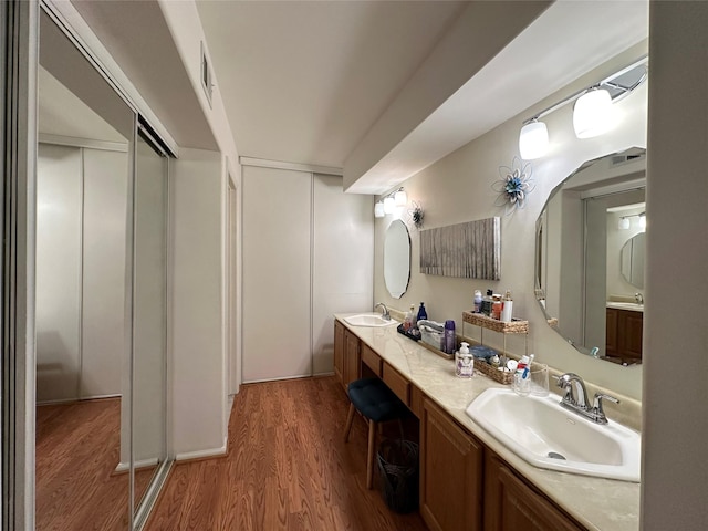 5 Baldwin Ct, Ridge, NY 11961 - bathroom featuring wood finished floors, double vanity, and elevator