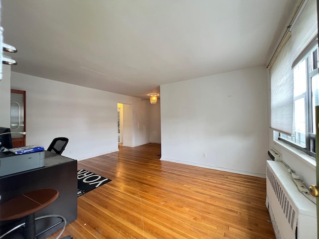 69-50 138th St Unit A, Flushing, NY 11367 - office featuring wood finished floors, radiator heating unit, and healthy amount of natural light