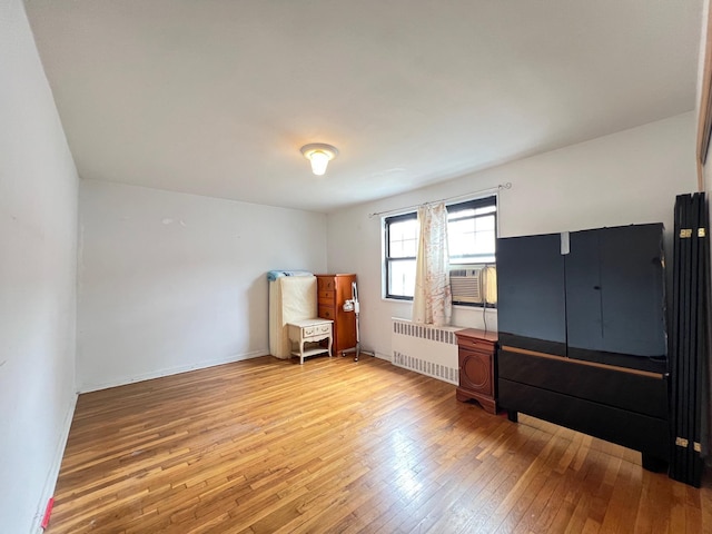 69-50 138th St Unit A, Flushing, NY 11367 - unfurnished room featuring radiator, light wood-type flooring, and cooling unit
