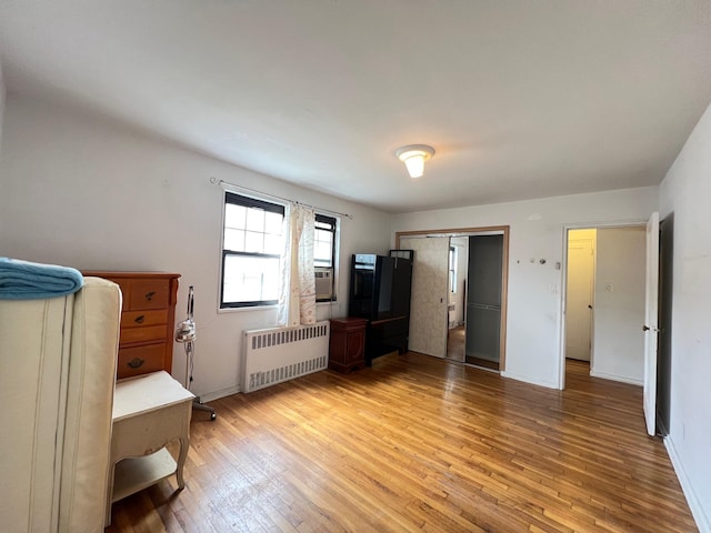 69-50 138th St Unit A, Flushing, NY 11367 - bedroom with radiator, light wood-style flooring, baseboards, and a closet