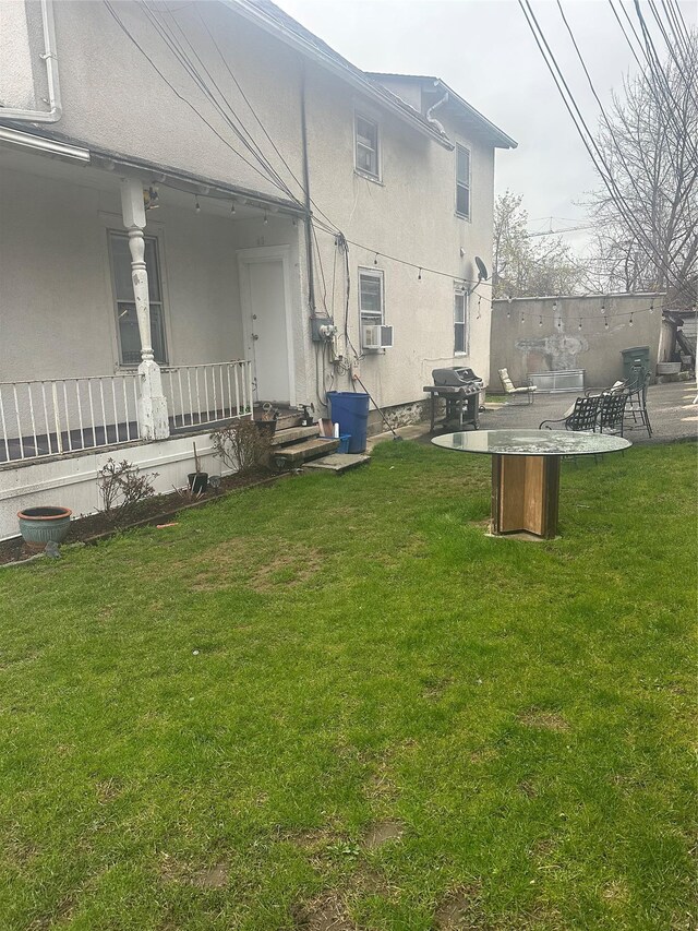 43 Oak St, Port Chester, NY 10573 - view of green lawn featuring cooling unit and covered porch