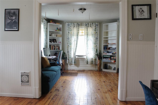 76 Foxhall Ave, Kingston, NY 12401 - sitting room featuring healthy amount of natural light, hardwood / wood-style flooring, wainscoting, and built in features