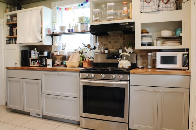 76 Foxhall Ave, Kingston, NY 12401 - kitchen featuring stainless steel range with gas stovetop, wood counters, white microwave, open shelves, and under cabinet range hood