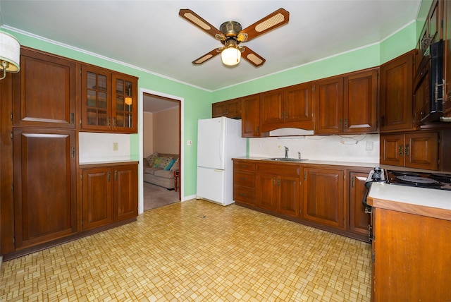 7 Sycamore Dr, Hyde Park, NY 12538 - kitchen with freestanding refrigerator, a sink, ceiling fan, light countertops, and light floors