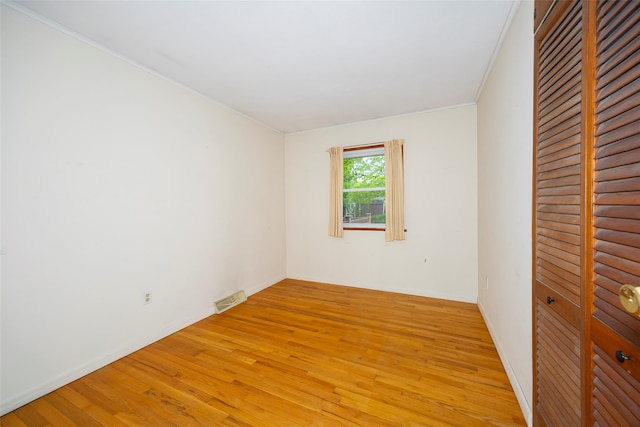 7 Sycamore Dr, Hyde Park, NY 12538 - unfurnished bedroom featuring light wood-style flooring, a closet, ornamental molding, and baseboards