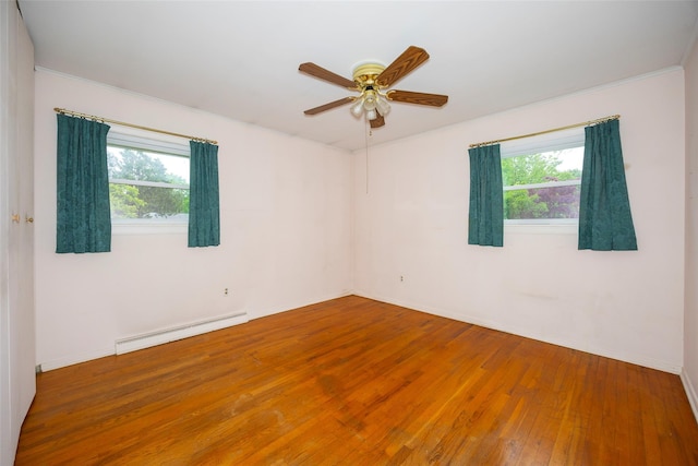 7 Sycamore Dr, Hyde Park, NY 12538 - unfurnished room featuring a baseboard heating unit, hardwood / wood-style flooring, a ceiling fan, baseboards, and ornamental molding