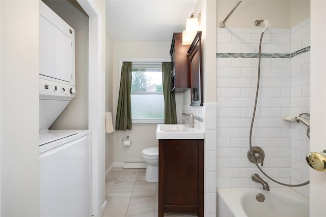 7 Sycamore Dr, Hyde Park, NY 12538 - full bathroom featuring stacked washer / dryer, baseboard heating, vanity, toilet, and  shower combination