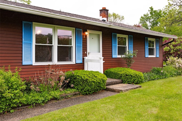 7 Sycamore Dr, Hyde Park, NY 12538 - view of front of house with a chimney and a front yard
