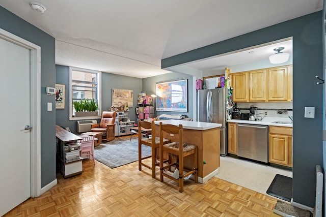 102 Bradhurst Ave Unit 906, New York Manhattan, NY 10039 - kitchen featuring stainless steel appliances, light countertops, a breakfast bar, a center island, and a sink