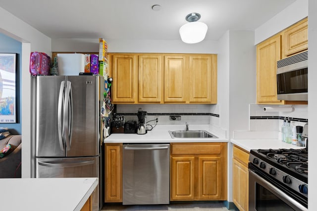 102 Bradhurst Ave Unit 906, New York Manhattan, NY 10039 - kitchen featuring stainless steel appliances, a sink, decorative backsplash, and light countertops