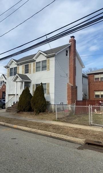 1113 5th Ave, New Hyde Park, NY 11040 - view of side of home featuring a chimney