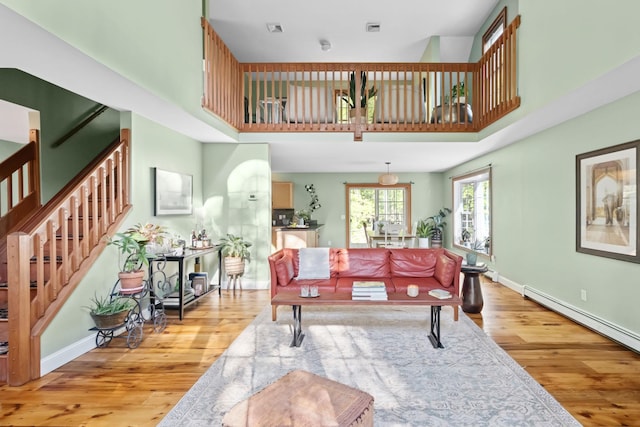 1401 State Route 28a, Hurley, NY 12491 - living area with light wood finished floors, stairs, a baseboard radiator, baseboards, and a high ceiling