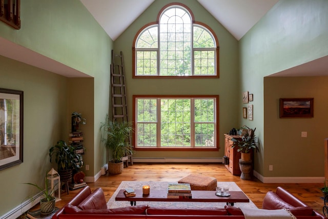 1401 State Route 28a, Hurley, NY 12491 - living room featuring a baseboard heating unit, high vaulted ceiling, and wood finished floors