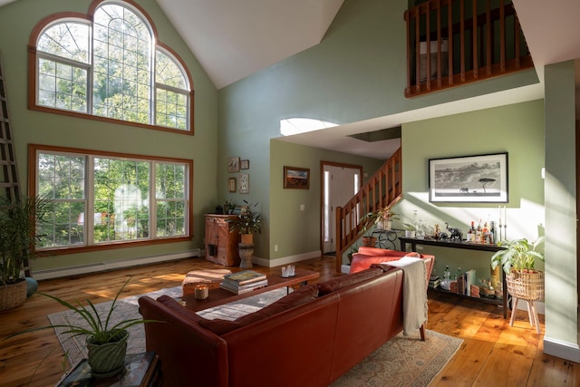 1401 State Route 28a, Hurley, NY 12491 - living room with high vaulted ceiling, baseboard heating, stairway, wood-type flooring, and baseboards