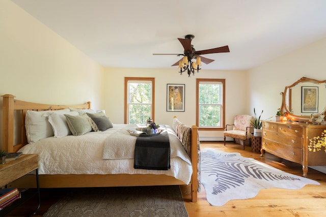 1401 State Route 28a, Hurley, NY 12491 - bedroom featuring wood finished floors, a baseboard heating unit, and ceiling fan