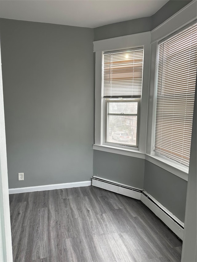 17 Chestnut St, Yonkers, NY 10701 - spare room with wood finished floors, a baseboard heating unit, and baseboards