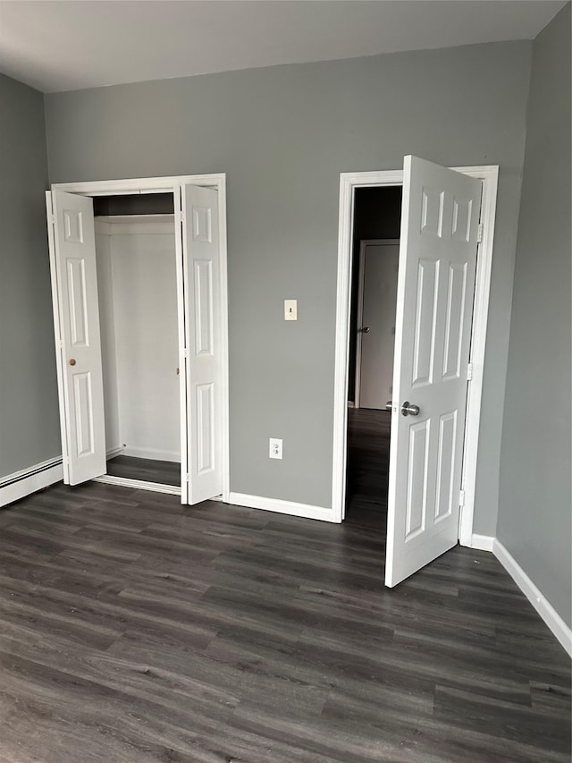 17 Chestnut St, Yonkers, NY 10701 - unfurnished bedroom featuring baseboards, dark wood-type flooring, a baseboard radiator, and a closet