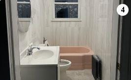 17 Chestnut St, Yonkers, NY 10701 - full bathroom featuring radiator heating unit, vanity, toilet, and tub / shower combination