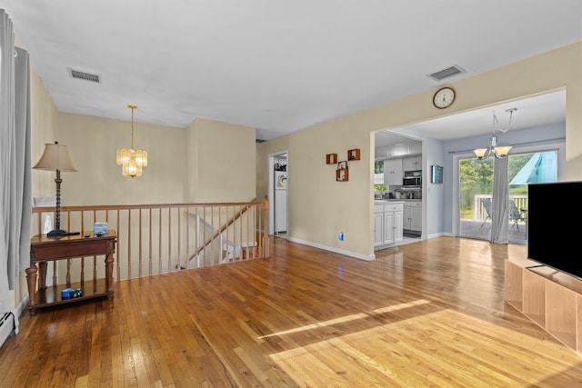 37 Lakeview Rd, Carmel, NY 10512 - living area with a chandelier, hardwood / wood-style floors, and a baseboard heating unit