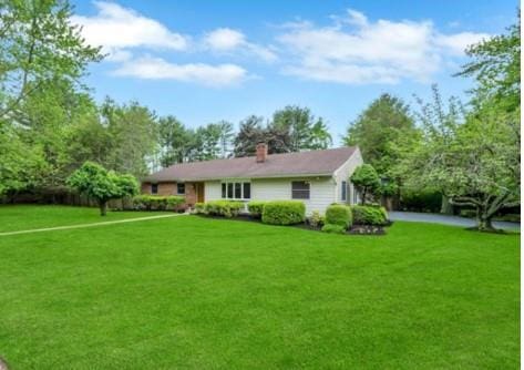 22 Peachtree Ln, Mount Sinai, NY 11766 - back of property with a lawn and a chimney