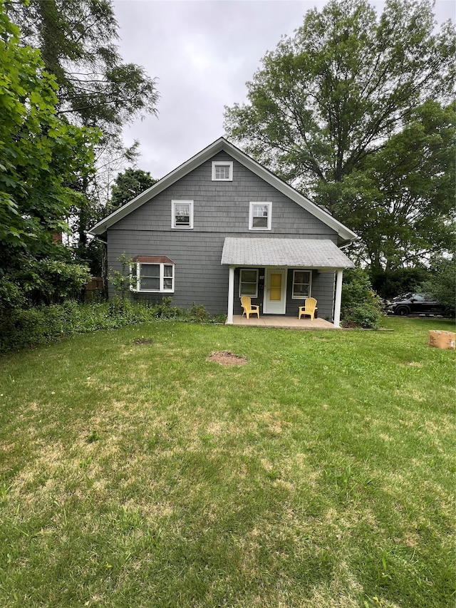 57 Juniper Ave, Smithtown, NY 11787 - back of property featuring a lawn and covered porch