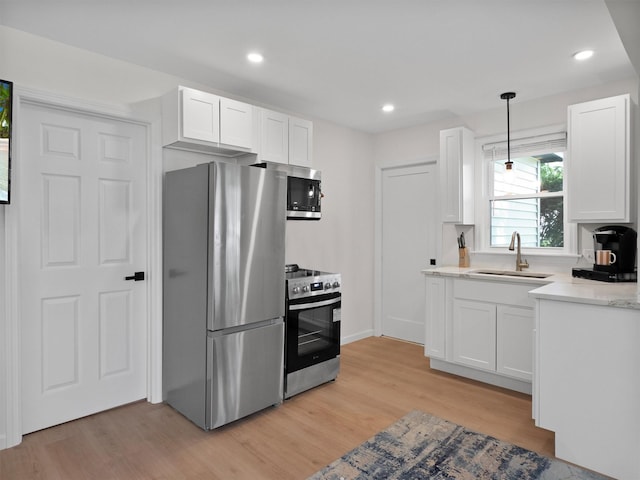 17 Woodlands Ter, Greenwood Lake, NY 10925 - kitchen with appliances with stainless steel finishes, a sink, light wood-type flooring, white cabinets, and recessed lighting
