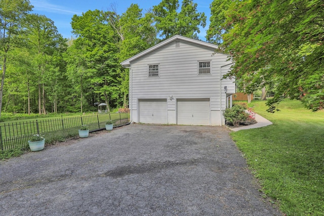 33 Greentree Dr N, Hyde Park, NY 12538 - view of side of home featuring asphalt driveway and an attached garage