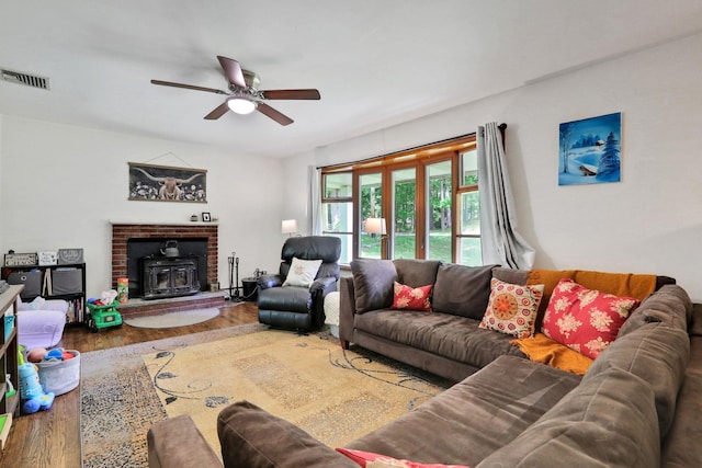 33 Greentree Dr N, Hyde Park, NY 12538 - living area featuring a wood stove, wood finished floors, and a ceiling fan