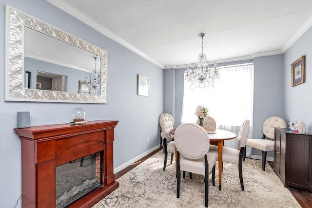 333 E Broadway Unit 1D, Long Beach, NY 11561 - dining area featuring a chandelier, wood finished floors, crown molding, and baseboards
