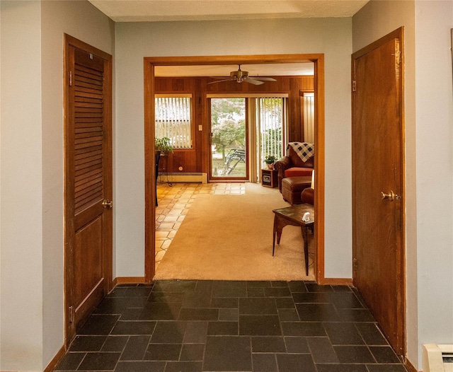 26 Stacey Dr, Monticello, NY 12701 - corridor featuring a baseboard heating unit, baseboards, and dark colored carpet