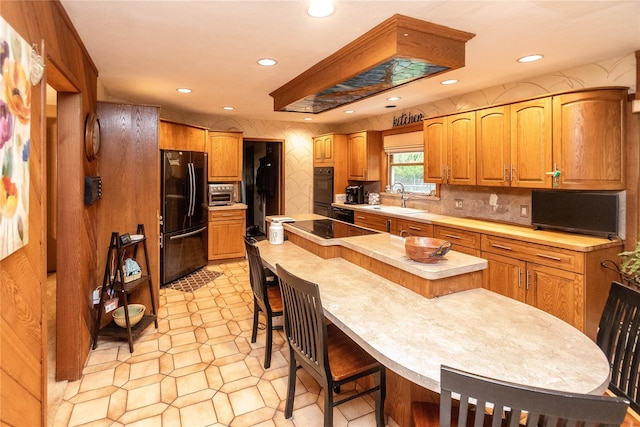26 Stacey Dr, Monticello, NY 12701 - kitchen featuring black appliances, a sink, light countertops, recessed lighting, and a center island