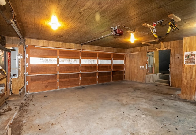 26 Stacey Dr, Monticello, NY 12701 - garage featuring wood ceiling, wooden walls, and a garage door opener