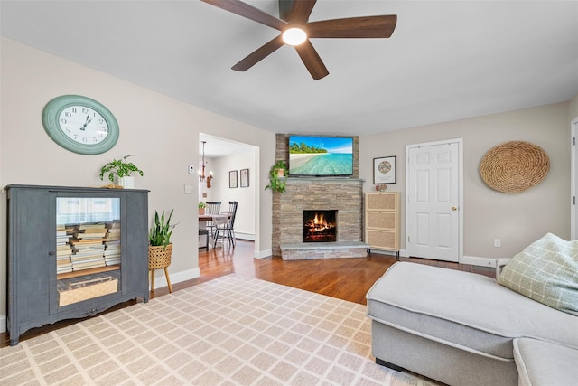 65 Awosting Rd, Pine Bush, NY 12566 - living room with a ceiling fan, wood finished floors, a stone fireplace, and baseboards