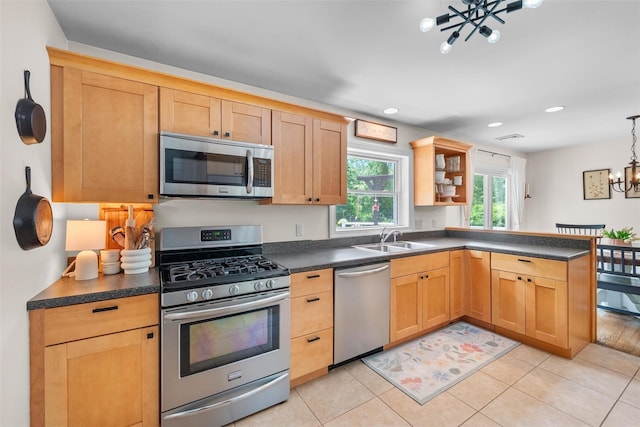 65 Awosting Rd, Pine Bush, NY 12566 - kitchen with stainless steel appliances, a chandelier, a sink, dark countertops, and a peninsula