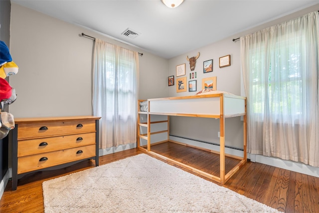 65 Awosting Rd, Pine Bush, NY 12566 - bedroom featuring wood finished floors and a baseboard heating unit