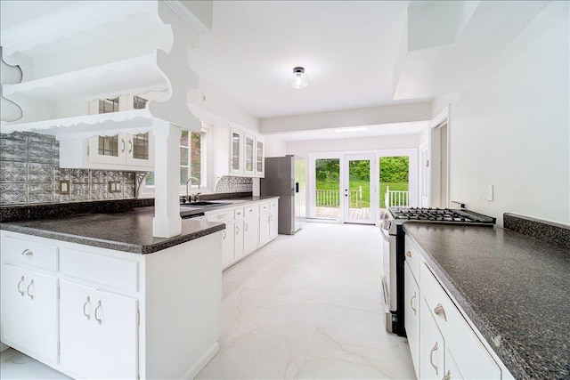 665 State Route 94 N, Warwick, NY 10990 - kitchen featuring appliances with stainless steel finishes, french doors, dark countertops, a sink, and tasteful backsplash