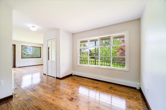 665 State Route 94 N, Warwick, NY 10990 - empty room with baseboard heating, wood finished floors, and baseboards