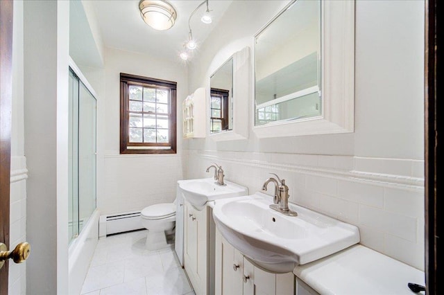 665 State Route 94 N, Warwick, NY 10990 - bathroom featuring a baseboard radiator, toilet, tile walls, shower / bath combination with glass door, and vanity