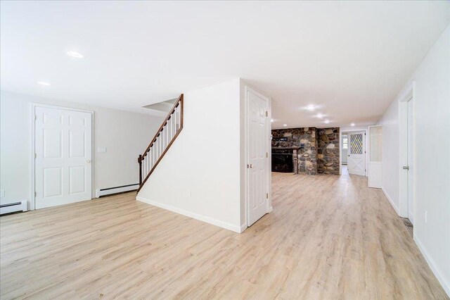 665 State Route 94 N, Warwick, NY 10990 - unfurnished living room featuring light wood-style flooring, stairway, recessed lighting, a baseboard radiator, and baseboards