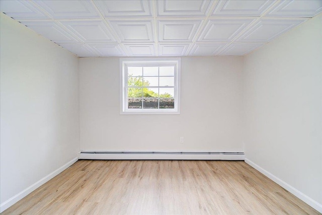 665 State Route 94 N, Warwick, NY 10990 - unfurnished room featuring baseboards, wood finished floors, baseboard heating, and an ornate ceiling