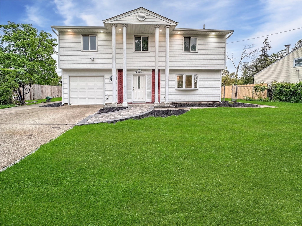 19 Leaf Ave, Central Islip, NY 11722 - view of front facade featuring driveway and an attached garage