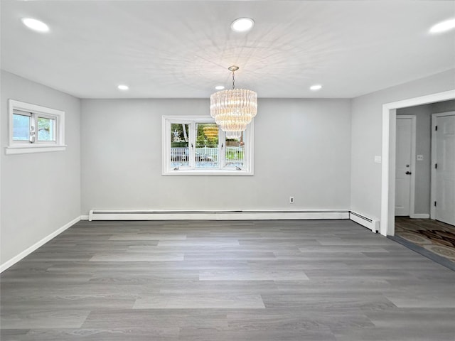 19 Leaf Ave, Central Islip, NY 11722 - unfurnished dining area with recessed lighting, a chandelier, wood finished floors, baseboards, and a baseboard radiator